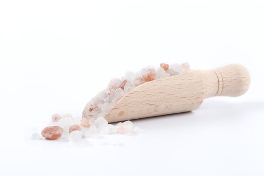 Himalayan Salt Raw Crystals Pile with Brown Wood Spice Scoop Isolated on White Background