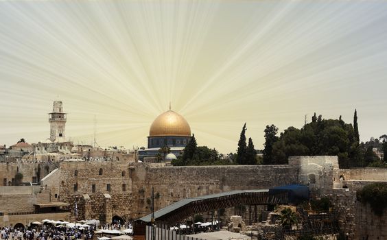 The western wall and Dome of the Rock with sun rays in the sky