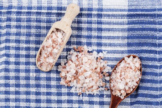 Himalayan Salt Raw Crystals in Two Wood Spons on Blue Ktchen Cloth Background