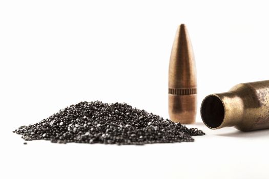 Rifle Bullet and Shel near pile of gunpowder isolated on white