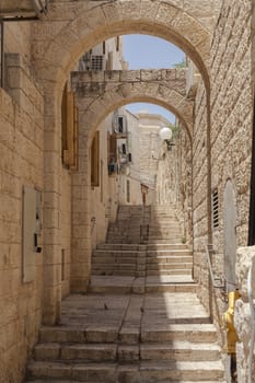 Narrow jerusalme street with stairs and stone walls
