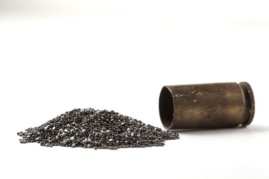 Rifle Bullet and Shel near pile of gunpowder isolated on white