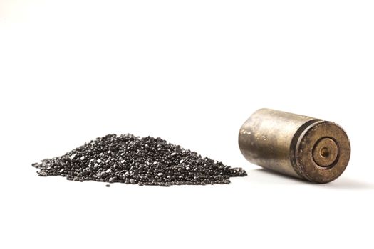 Rifle Bullet and Shel near pile of gunpowder isolated on white