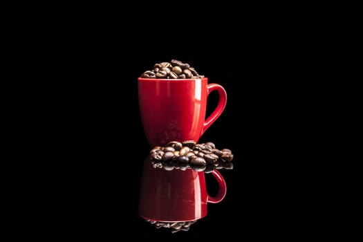 Cup and coffee isolated on black background with reflexion