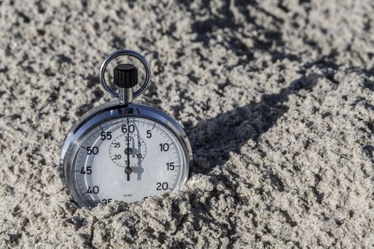 analog Stopwatch in hand with sea in the background