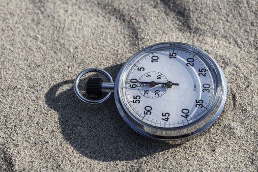 analog Stopwatch on wet sea sand