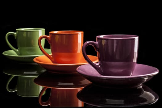 Cups isolated on black background with reflexion