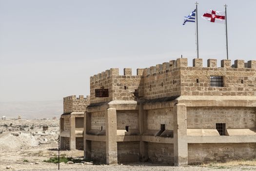 A view of old building with flags on it