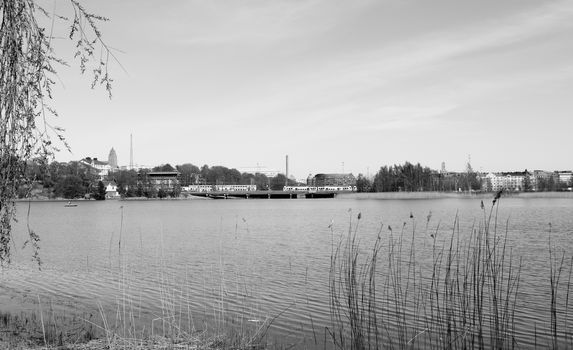 VR Pendolino trains cross a bridge on the far side of Toolo bay in Helsinki City Park - monochrome processing