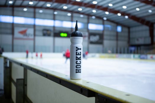 drink white bottle on board ice hockey rink