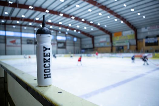 drink white bottle on board ice hockey rink