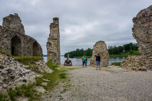 Koknese castle ruins. Latvian medieval castles. Archaeological monument of national importance. Tourists take pictures at old castle ruins Koknese, Latvia. The medieval castle of Koknese was a stone castle built in the medieval castle mound in Koknese, on the bank of the Daugava. Built shortly after 1209