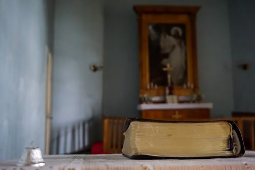 Evangelic Lutheran Church in Koknese, Latvia. Interior of Koknese church. Bible and bell at the Koknese Evangelical Lutheran Church. Church was built in 1687. 