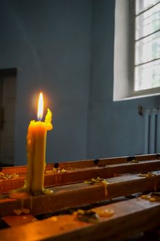 Burning candle at Koknese Evangelical Lutheran Church. Evangelic Lutheran Church in Koknese, Latvia. Interior of Koknese church. Church was built in 1687. 