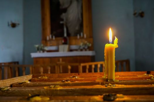 Burning candle at Koknese Evangelical Lutheran Church. Evangelic Lutheran Church in Koknese, Latvia. Interior of Koknese church. Church was built in 1687. 