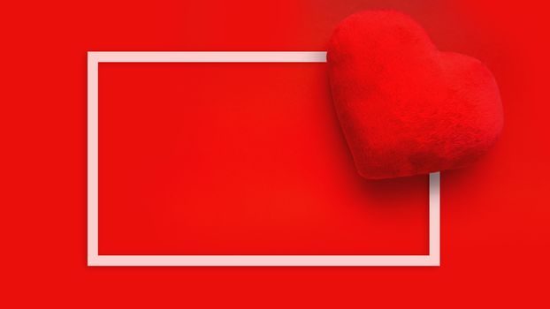 Valentines day love background with soft toy heart on red background. Top view. For banner, cards design