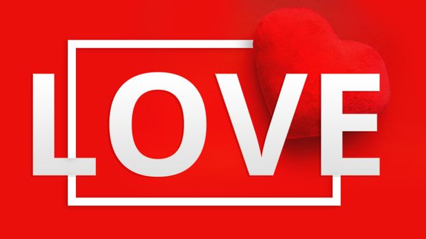 Valentines day background with soft toy heart and word Love in white color on red background. Top view. For banner, cards design