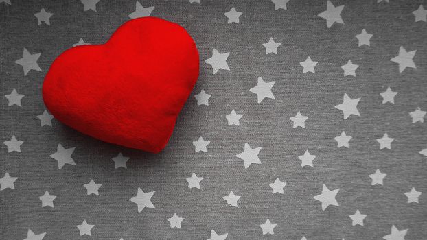 Valentines day background with soft toy heart on a gray background with white stars. Top view. for banner, cards design