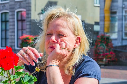 Beauty portrait of a relaxed woman with dreamy face and chin on her fist looking into the camera.