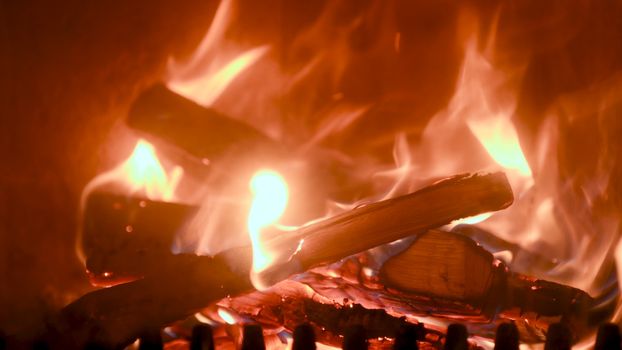 Fire in stove, close up, firewood burning, detail interior scene, winter concept