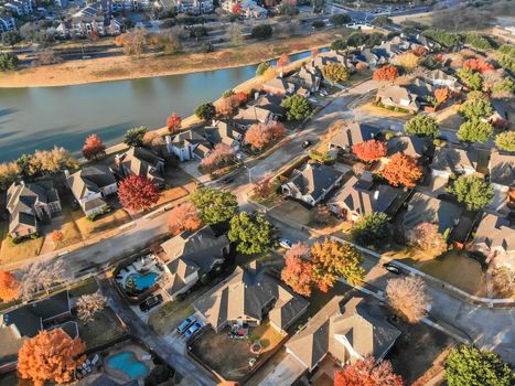 Aerial view lakefront neighborhood with cul-de-sac dead-end street near Dallas, Texas. Morning autumn season with colorful fall foliage leaves