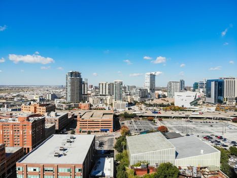 Aerial drone view uptown Dallas, Texas during sunny autumn day. Dense of modern skylines office building along Texas State Highway Spur 366 (Woodall Rodgers Freeway), colorful fall leaves