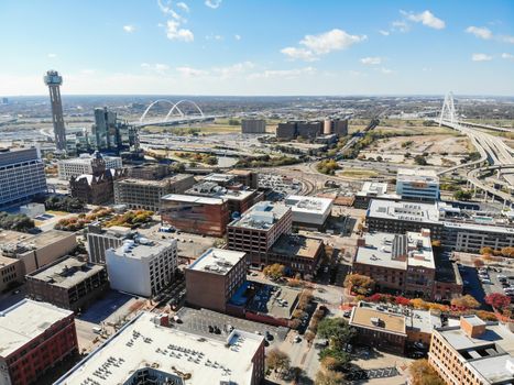 Aerial drone view uptown Dallas, Texas with two landmark bridges Margaret Hunt Hill Bridge and Margaret McDermott Bridge in background. Flyover Texas State Highway Spur 366 (Woodall Rodgers Freeway)