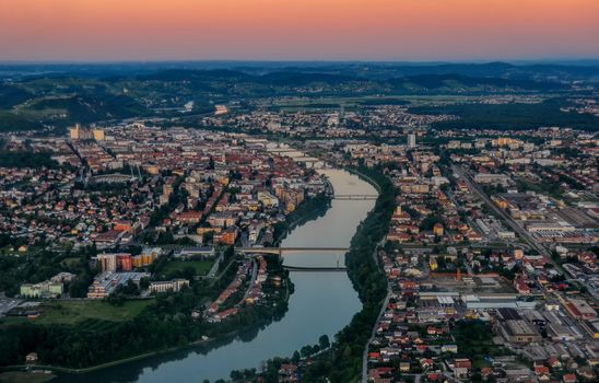 Aerial view of european city with river and bridges at sunset, Maribor, Slovenia from air