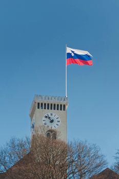 Tower of Ljubljana castle with Slovenian flag flying above the tower