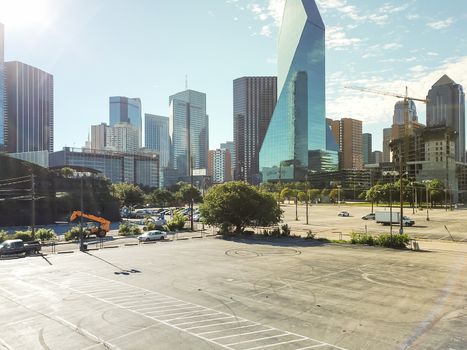 Aerial view large parking lots in downtown Dallas, Texas near highway with skylines in background