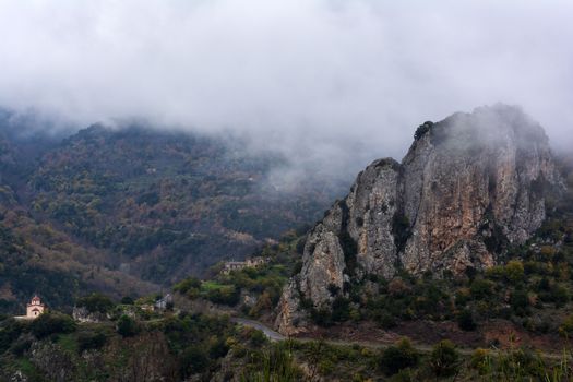 Image of village in the mountains with fog, Arcadia, Greece.