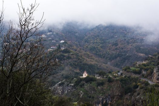 Image of village in the mountains with fog, Arcadia, Greece.