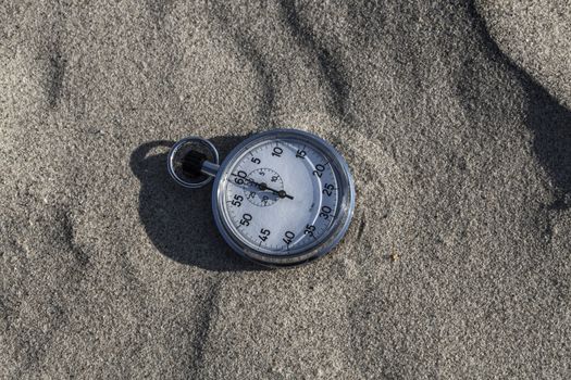 analog Stopwatch on wet sea sand