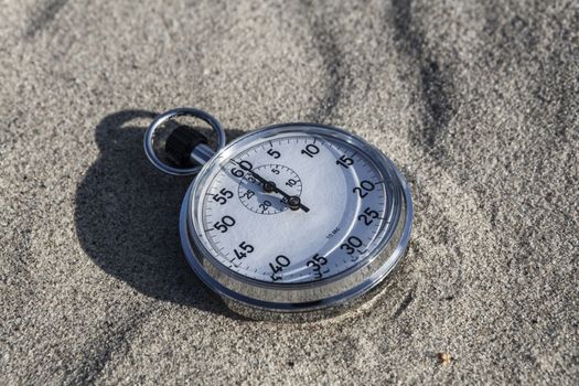 analog Stopwatch on wet sea sand