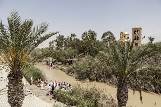 A view of people wearing white near water