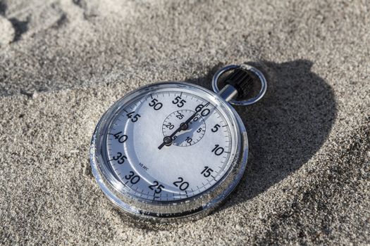 analog Stopwatch on wet sea sand