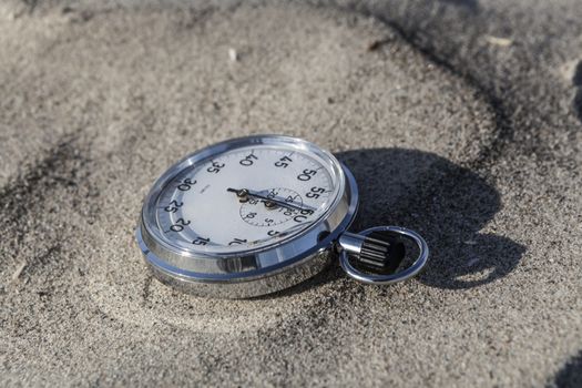 analog Stopwatch on wet sea sand