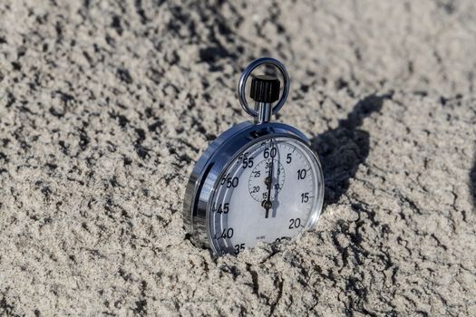 analog Stopwatch in hand with sea in the background