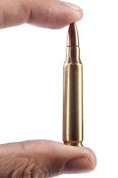 Fingers Holding Single Rifle Bullet Isolated On White Background