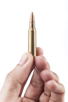 Fingers Holding Single Rifle Bullet Isolated On White Background