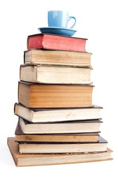 Old Books  and blue coffee mug isolated on white background