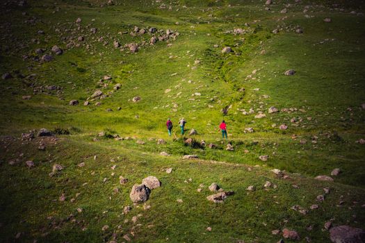 hikers with backpacks and trekking poles walking in Turkish highland