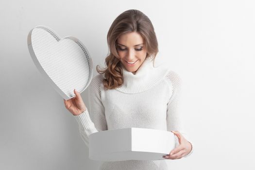 Pretty girl open heart shaped gift box on Valentines day