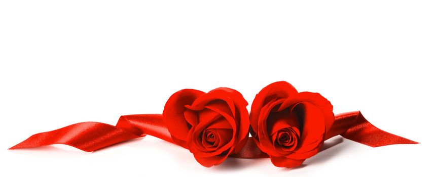 Two Beautiful heart shaped Red Roses with red ribbons isolated on white background