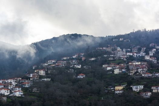 Image of village in the mountains with fog, Arcadia, Greece.