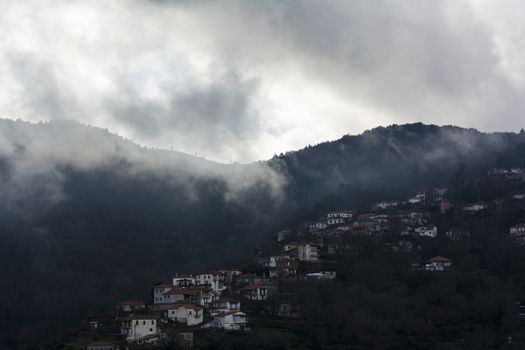 Image of village in the mountains with fog, Arcadia, Greece.