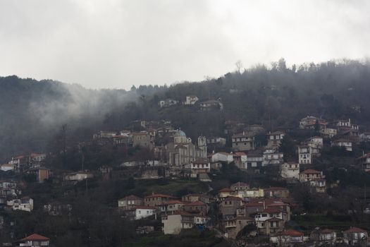 Image of village in the mountains with fog, Arcadia, Greece.