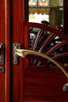 Old stylish wooden door with nice brass doorknob