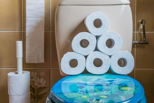 pile of stacked toilet paper on the water closet seat, interior of a bathroom, sanitary background