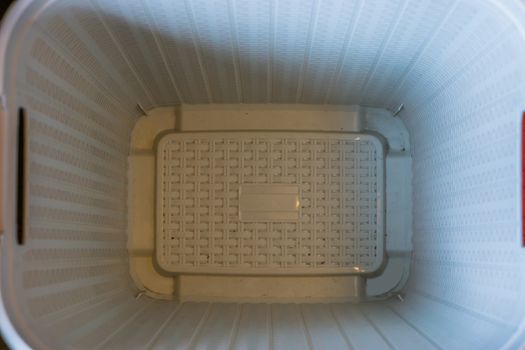 inside of a empty plastic laundry basket, household background